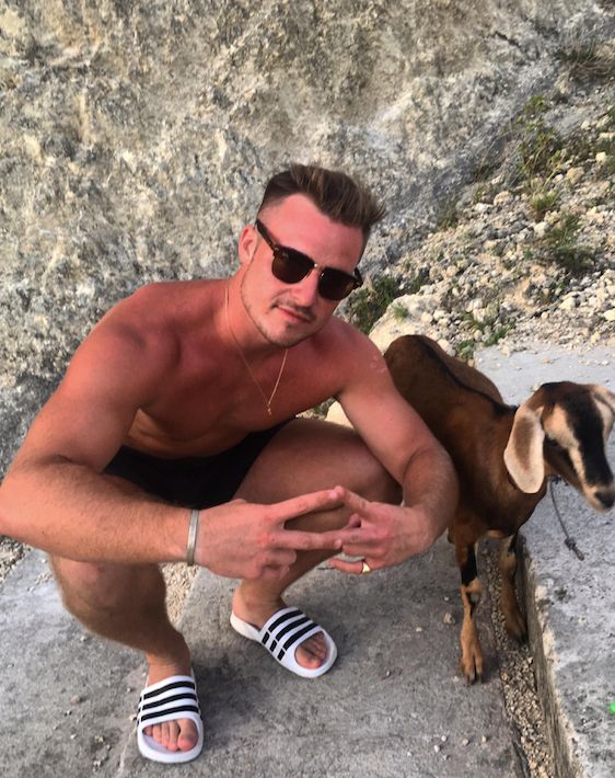 Image may contain: Rock, Goat, Animal, Mammal, Footwear, Apparel, Clothing, Shoe, Person, Human, Sunglasses, Accessories, Accessory