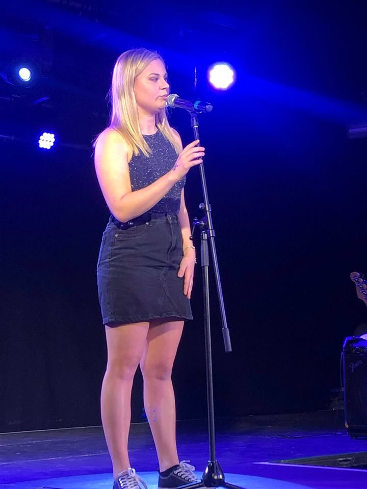 Image may contain: Shoe, Footwear, Crowd, Leisure Activities, Stage, Musical Instrument, Musician, Woman, Child, Kid, Teen, Girl, Blonde, Female, Lighting, Apparel, Clothing, Person, Human