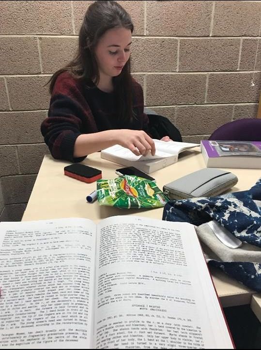 Image may contain: Text, Girl, Reading, Female, Apparel, Clothing, Desk, Table, Furniture, Person, Human, Book