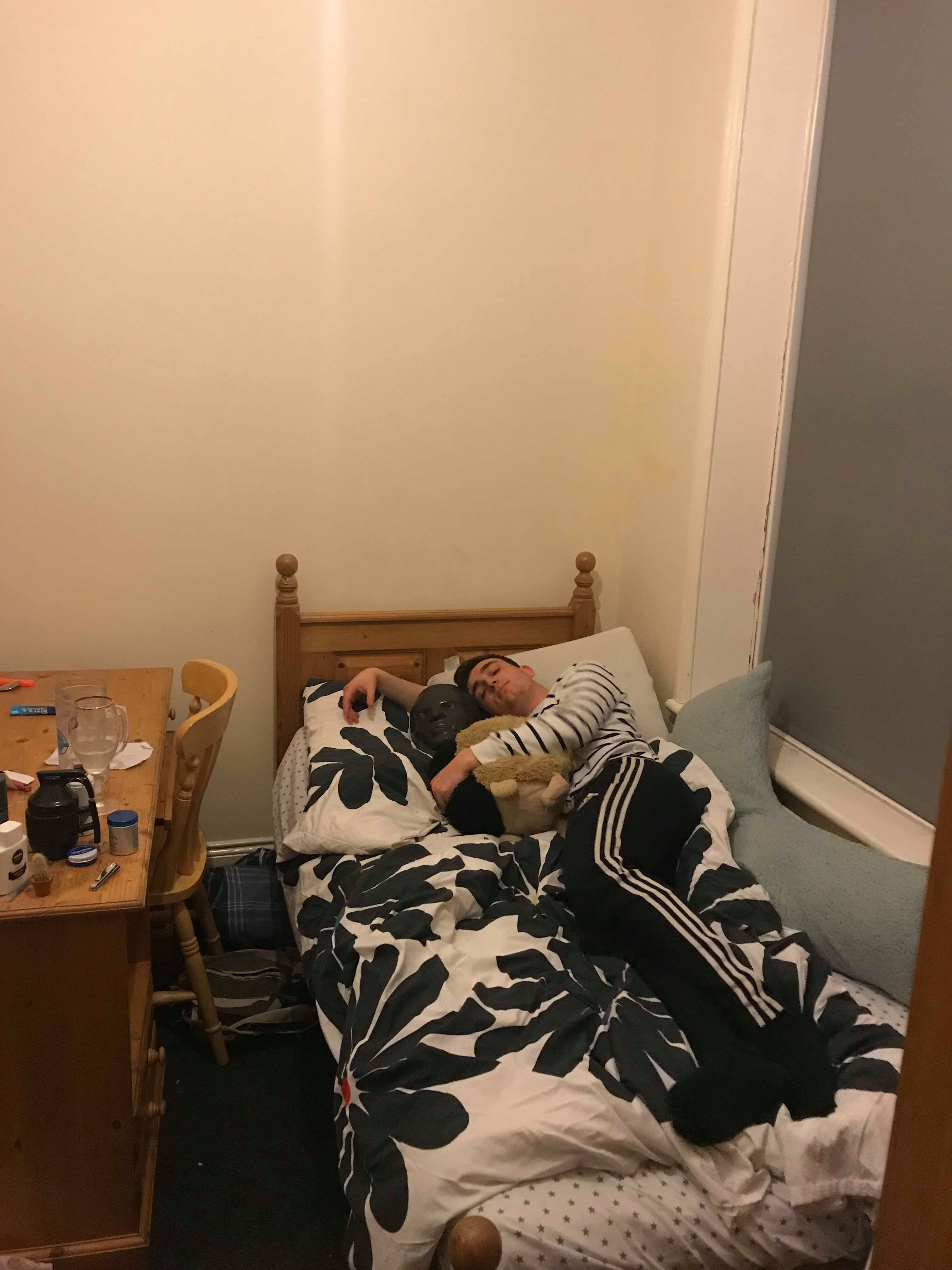 Image may contain: Dorm Room, Bed, Display, LCD Screen, Monitor, Screen, Flooring, Electronics, Plywood, Living Room, Shelf, Wood, Couch, Indoors, Room, Bedroom, Furniture