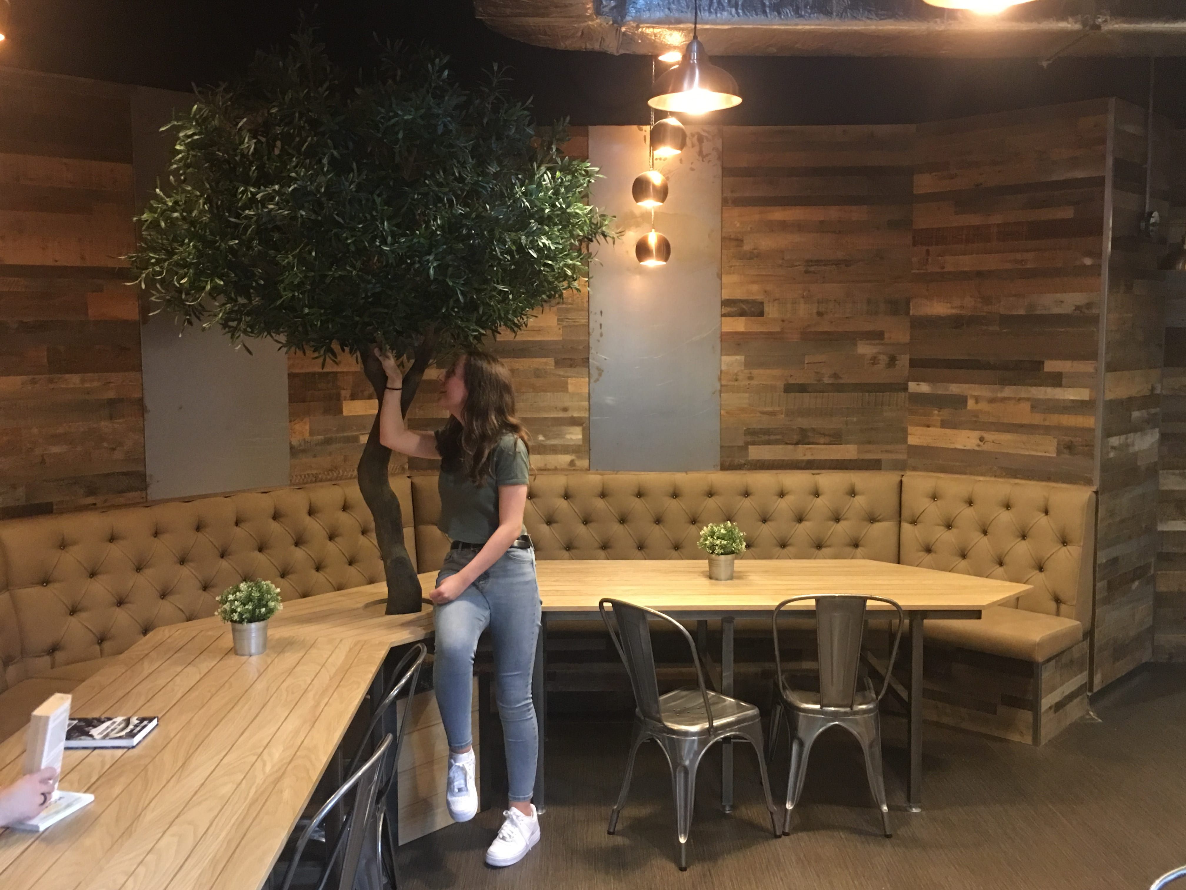 Image may contain: Tabletop, Cafeteria, Hardwood, Table, Lighting, Pants, Restaurant, Chair, Furniture, Clothing, Apparel, Footwear, Shoe, Person, Human, Plywood, Wood