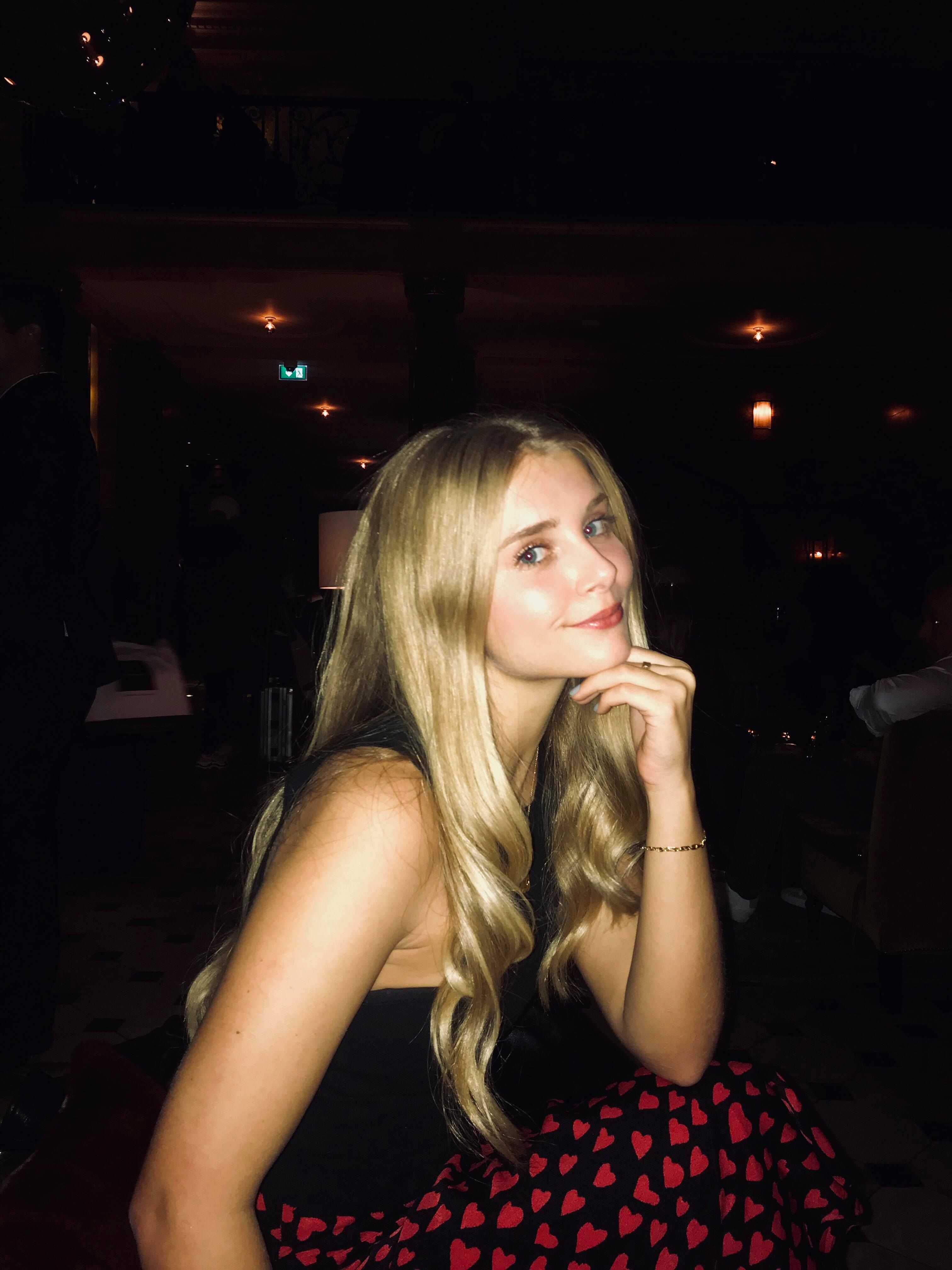Image may contain: Pub, Bar Counter, Night Club, Robe, Fashion, Evening Dress, Gown, Apparel, Clothing, Club, Night Life, Human, Person