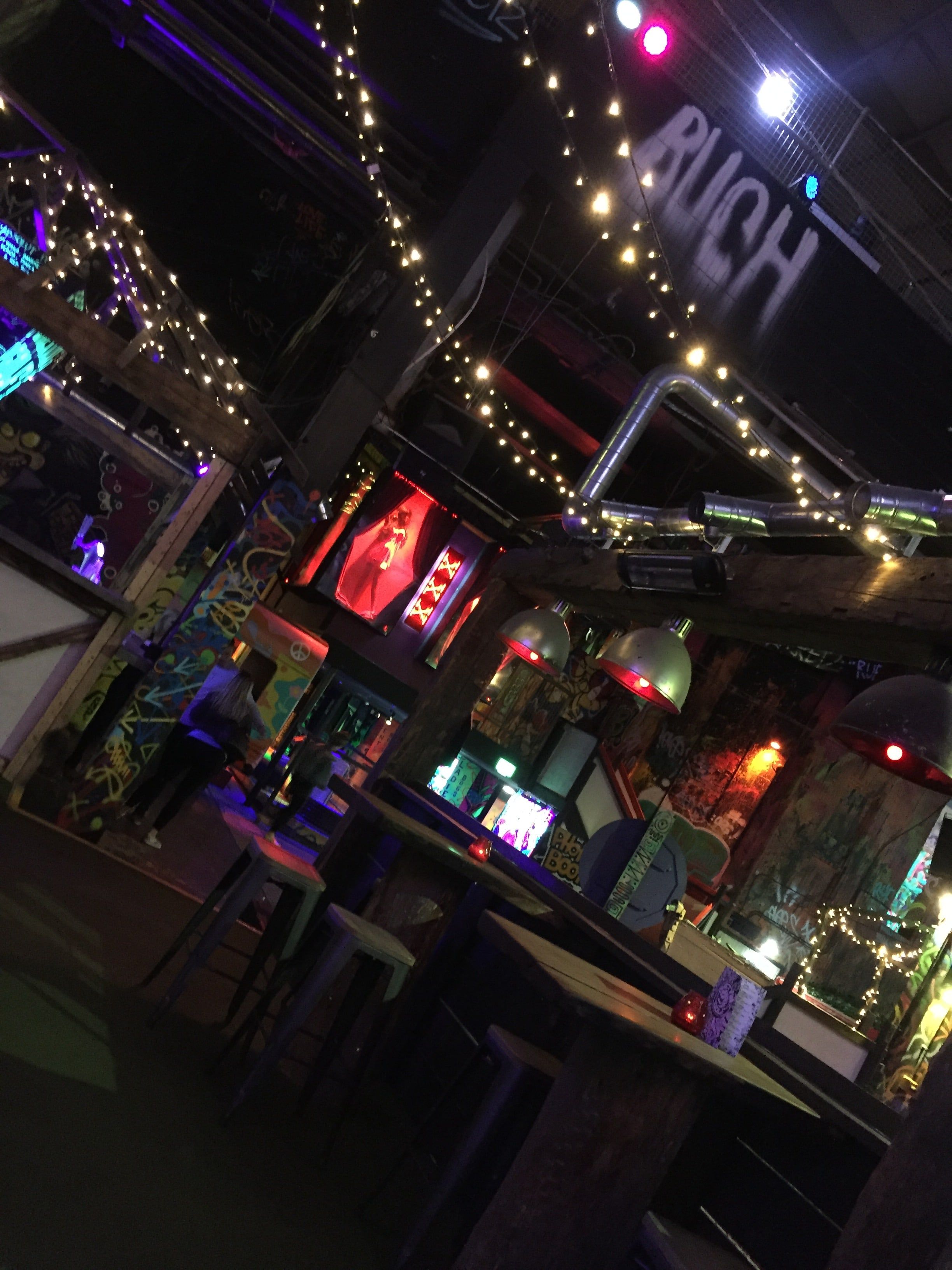 Image may contain: Arcade Game Machine, Bar Counter, Pub, Night Life, Lighting