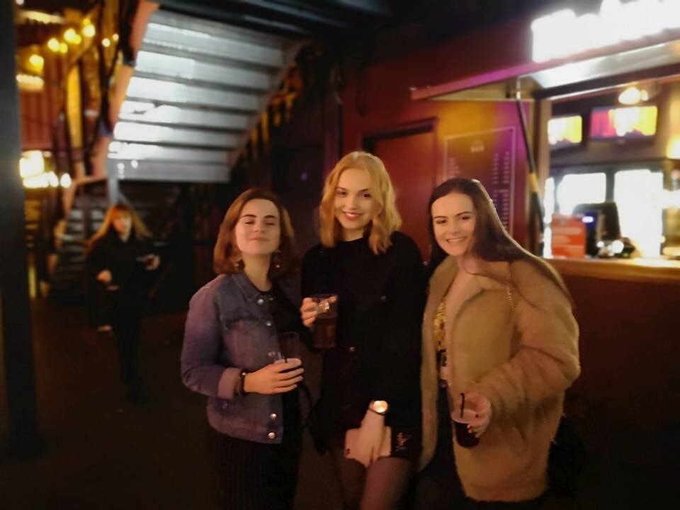 Image may contain: Coat, Alcohol, Beverage, Drink, Bar Counter, Clothing, Apparel, Pub, Kid, Woman, Girl, Child, Teen, Female, Blonde, Human, Person