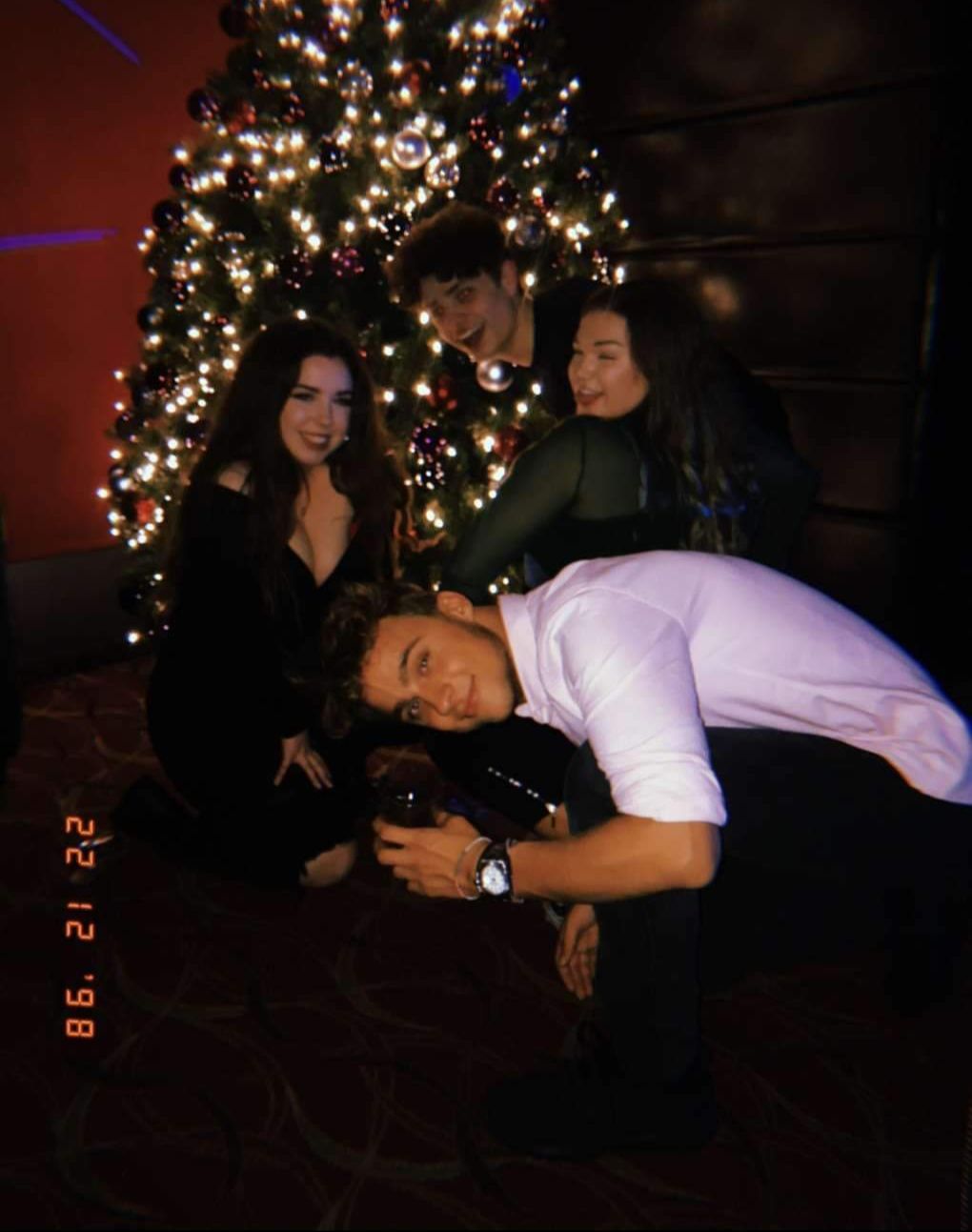 Image may contain: Woman, Girl, Face, Ornament, Christmas Tree, Tree, Plant, Pants, Female, Lighting, Apparel, Clothing, Night Life, Human, Person