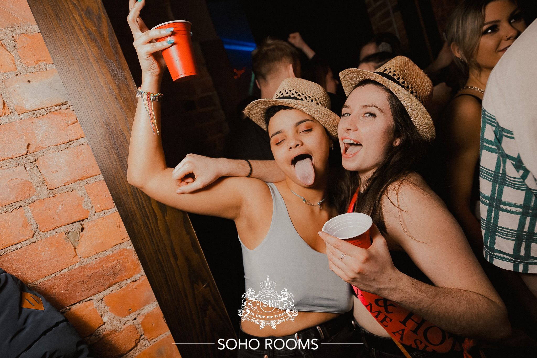 Image may contain: Finger, Night Life, Skin, Hat, Human, Person, Apparel, Clothing