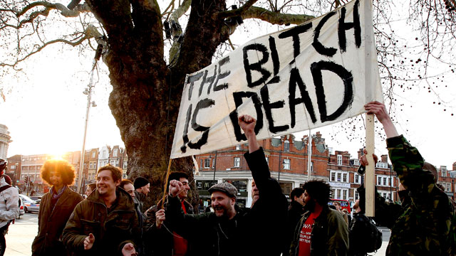 People hold banner celebrating Margaret Thatcher's death