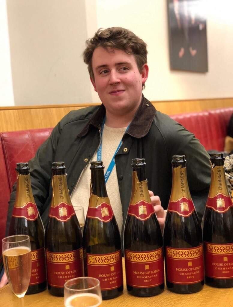 Image may contain: Beer Bottle, Wine, Furniture, Couch, Bottle, Beverage, Beer, Drink, Alcohol, Human, Person