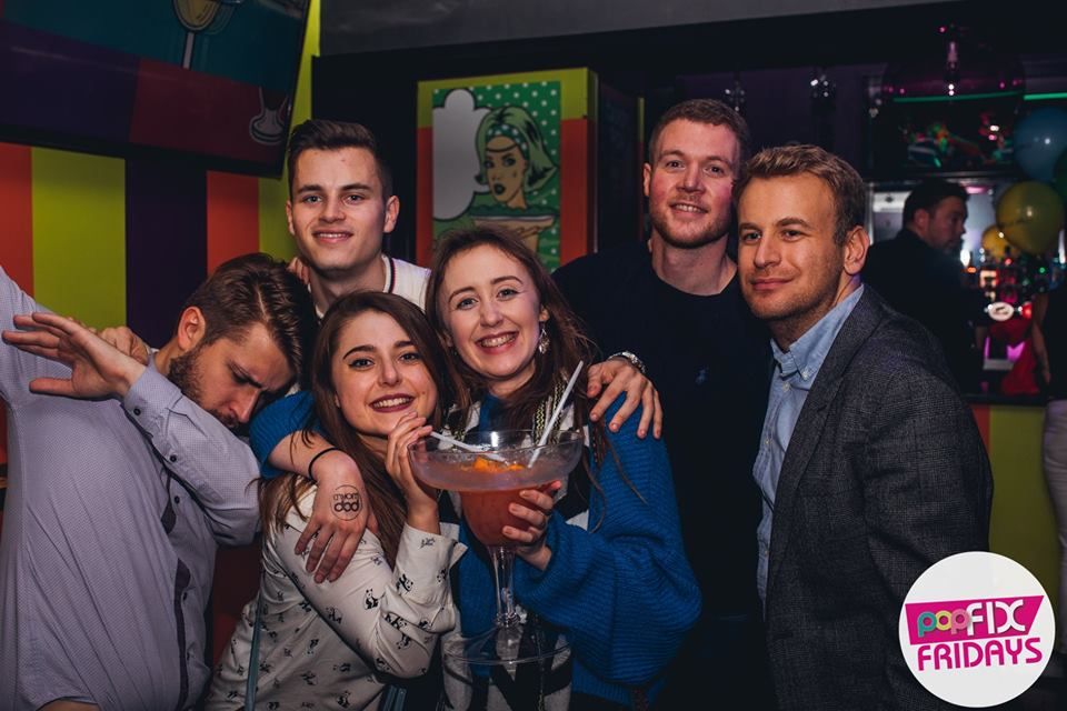 Image may contain: Face, Night Life, Bar Counter, Pub, Night Club, Overcoat, Coat, Suit, Clothing, Apparel, Club, Party, Person, Human