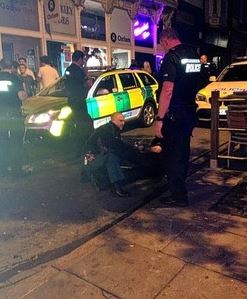 Police officers tend to their fallen colleague, who will be fuck hip-hopping for a while