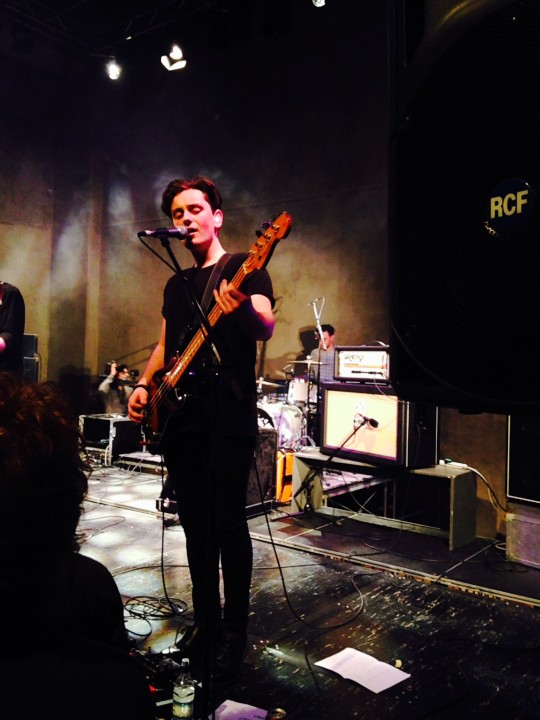 Playing bass and singing beautiful harmonies