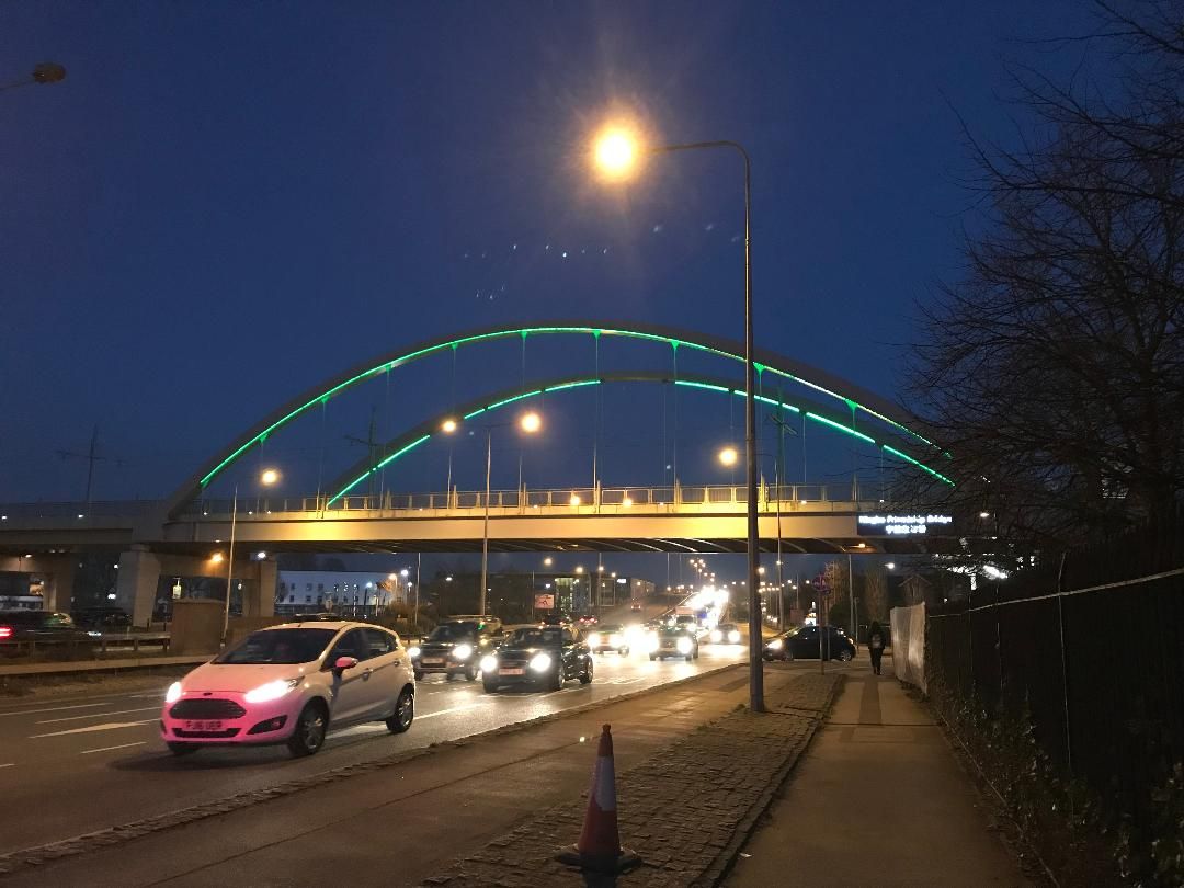 Image may contain: Arch Bridge, Bridge, Urban, Town, Metropolis, City, Arched, Arch, Human, Person, Freeway, Wheel, Machine, Building, Architecture, Road, Transportation, Automobile, Vehicle, Car