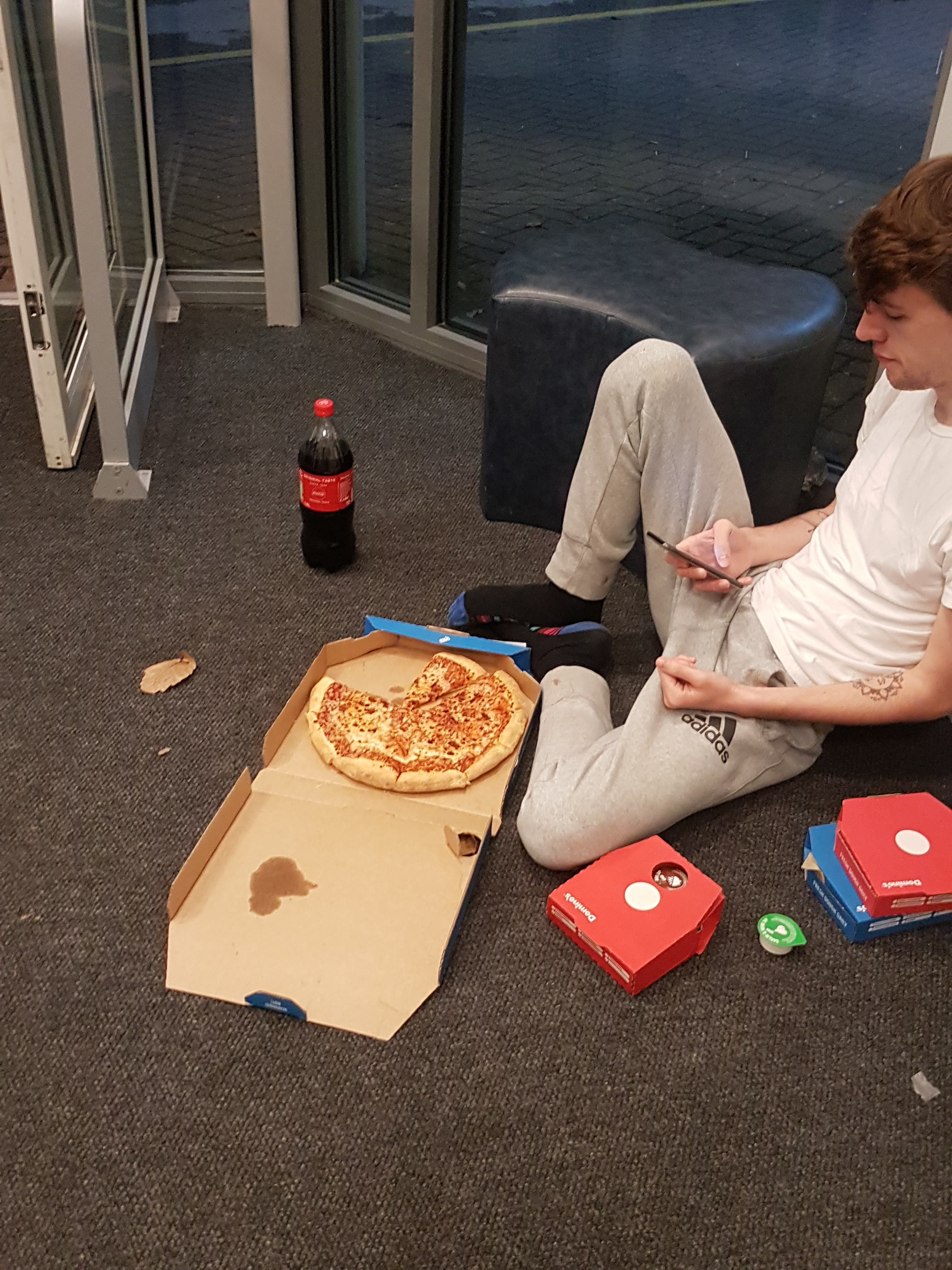 Image may contain: Pizza, Food, Couch, Furniture, Person, Human