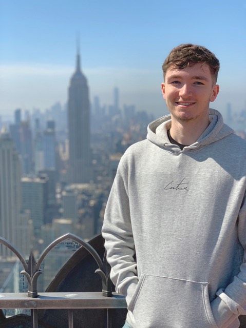 Image may contain: Man, Architecture, Face, Sweater, Sweatshirt, Person, Human, High Rise, Town, Urban, City, Building, Apparel, Clothing