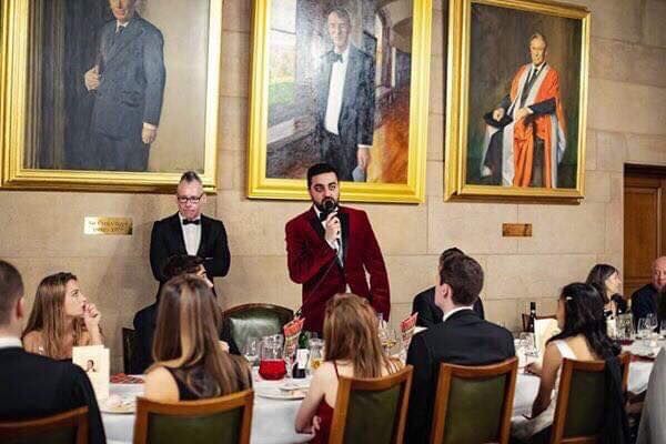 Image may contain: People, Dining Room, Art, Chair, Dining Table, Blazer, Jacket, Tuxedo, Indoors, Room, Table, Coat, Suit, Overcoat, Clothing, Apparel, Person, Human, Tabletop, Furniture