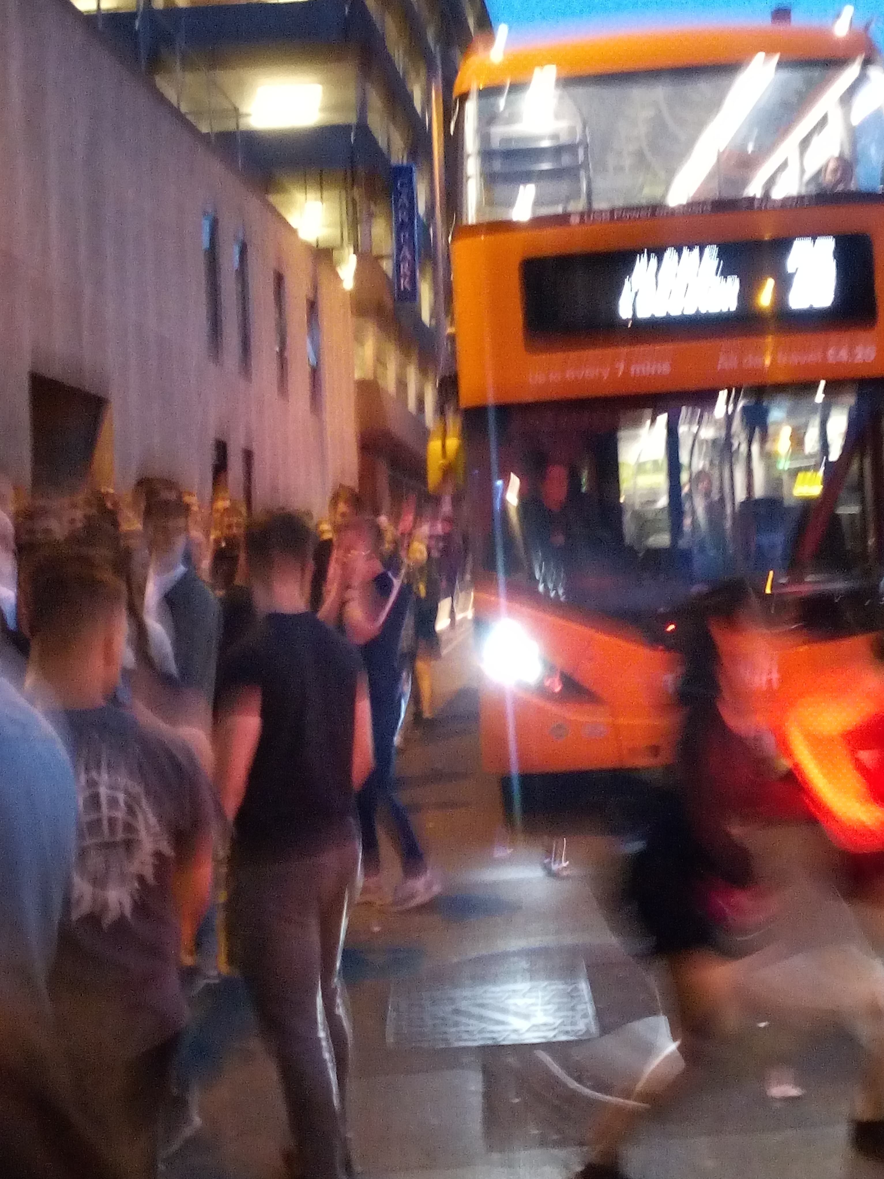 Image may contain: Double Decker Bus, Night Life, Tour Bus, Vehicle, Bus, Transportation, Human, Person