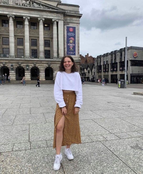 Image may contain: Dress, Downtown, Architecture, Footwear, Shoe, City, Building, Town, Urban, Long Sleeve, Skirt, Sleeve, Woman, Human, Female, Person, Apparel, Clothing