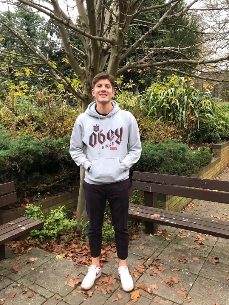 Image may contain: Bench, Hood, Plant, Wood, Furniture, Sweatshirt, Sweater, Human, Person, Shoe, Apparel, Footwear, Clothing