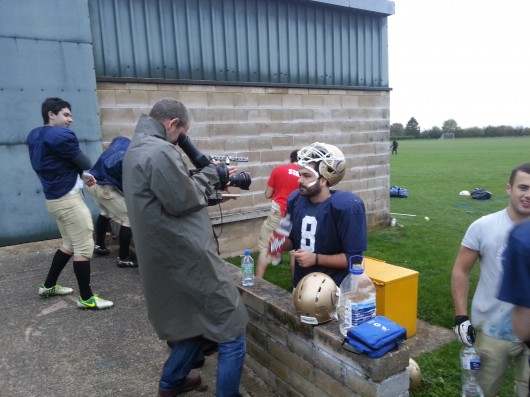 QB Panayiotis Christoforou just kinda stands there while they film him for like a minute. TV is weird.