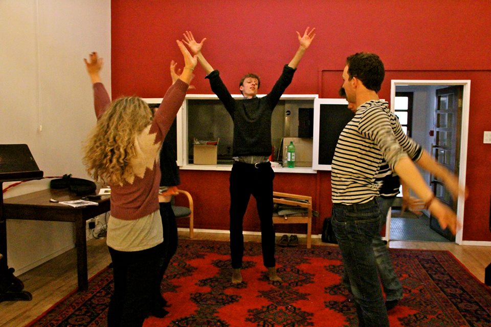 Director James Fennemore leads an energetic warm-up