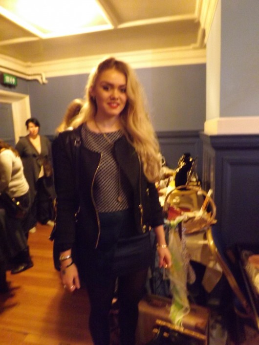 Emily Douey – A fitted leather jacket brightened up with a touch of red lipstick.  