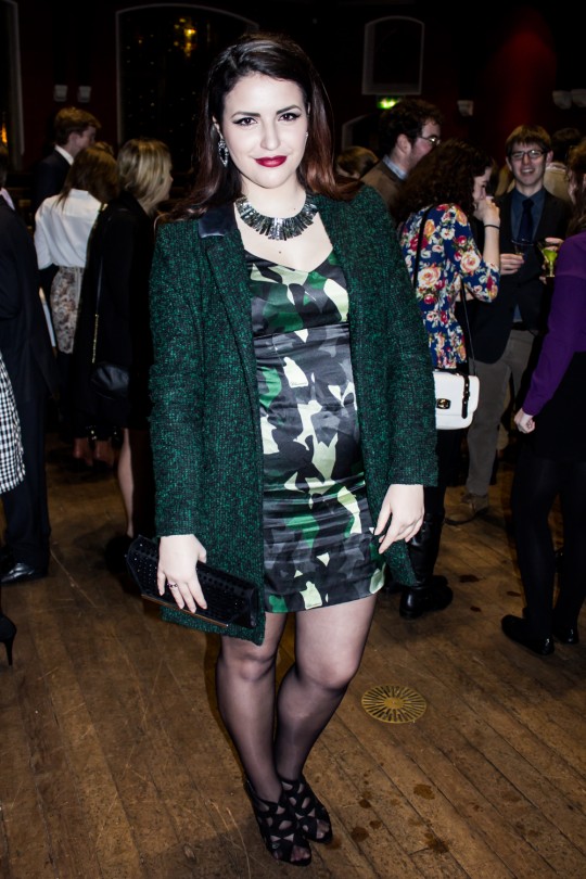 This girl looks great in this silk camo body-con dress and emerald-green blazer. A statement necklace and studded clutch add additional sparkle to a glamorous look.