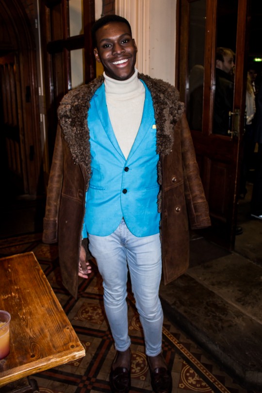 We love this guy's cosy and classic look , pairing a wool-lined leather jacket and cream roll-neck. He adds a splash of colour with this smart blue waistcoat.
