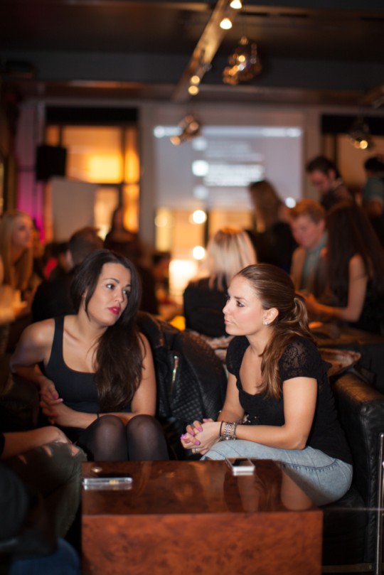 The woman on the right shows an understated look can still be stylish. Her jeans may be casual, but a perfect pink manicure, slick pony tail and lace detail top make this outfit anything but dull