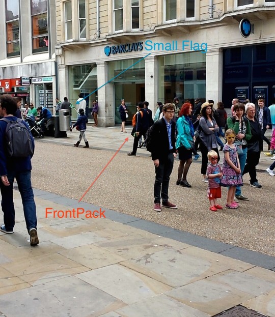A small group of asian tourists obscured by a family returning from a birthday party