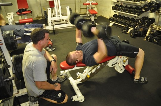 mediterranean-sea-gunners-mate-2nd-class-joshua-leach-spots-seaman-myles-stratton-while-lifting-weights-in-the-workout-room-aboard-uss-ponce-lpd-15