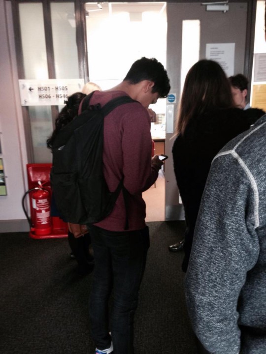 Students queuing to collect their timetables...r