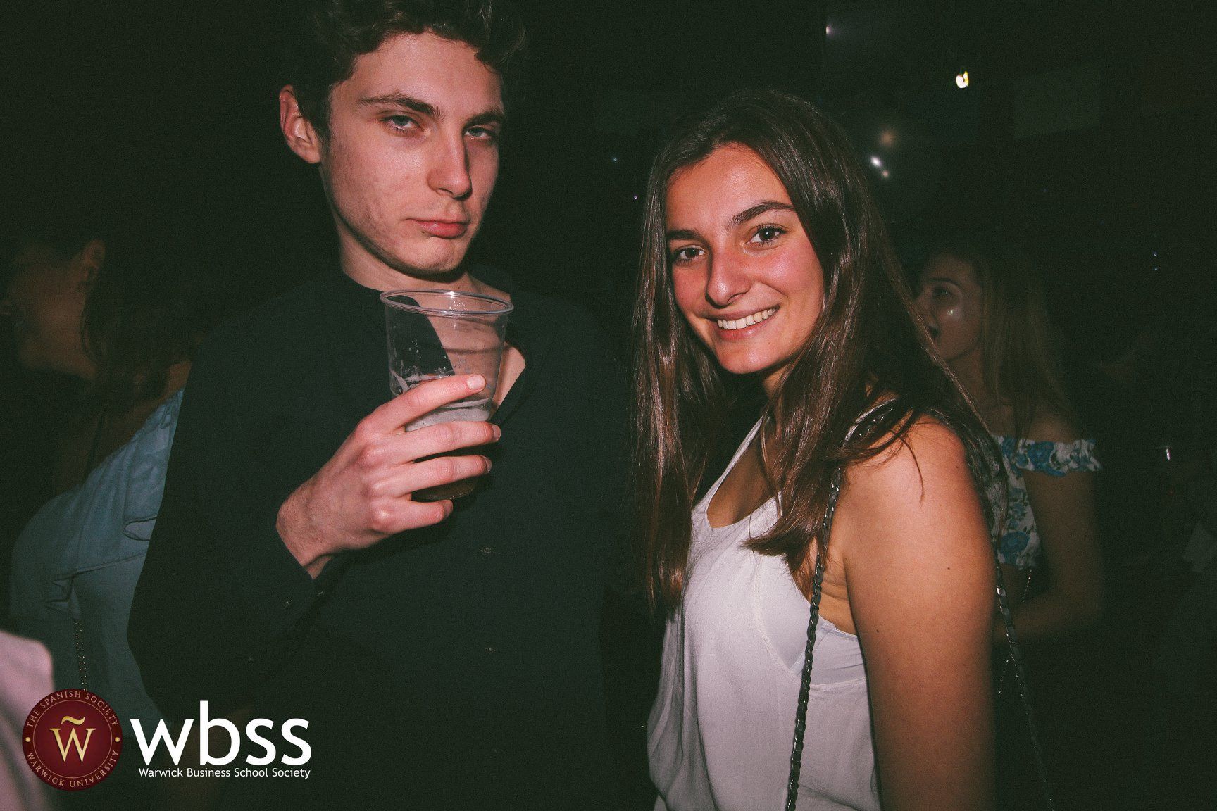 Image may contain: Trademark, Logo, Night Life, Night Club, Club, Shirt, Clothing, Person, People, Human