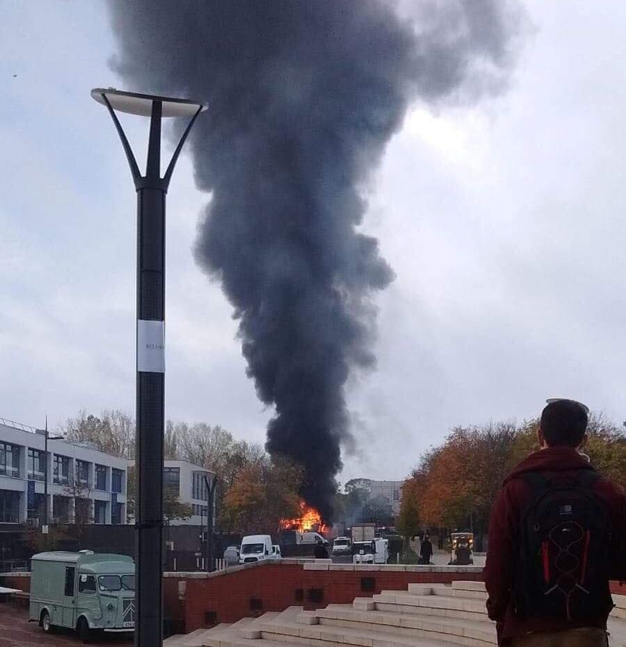 Image may contain: Vehicle, Transportation, Bus, Smoke, Person, People, Human