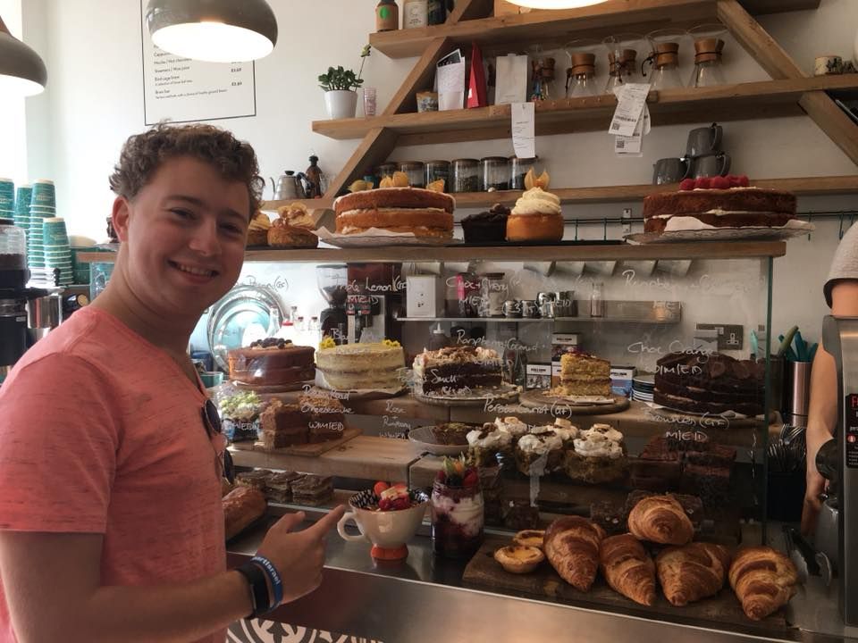 Image may contain: Interior Design, Indoors, Food, Bread, Shelf, Human, Person, Shop, Bakery