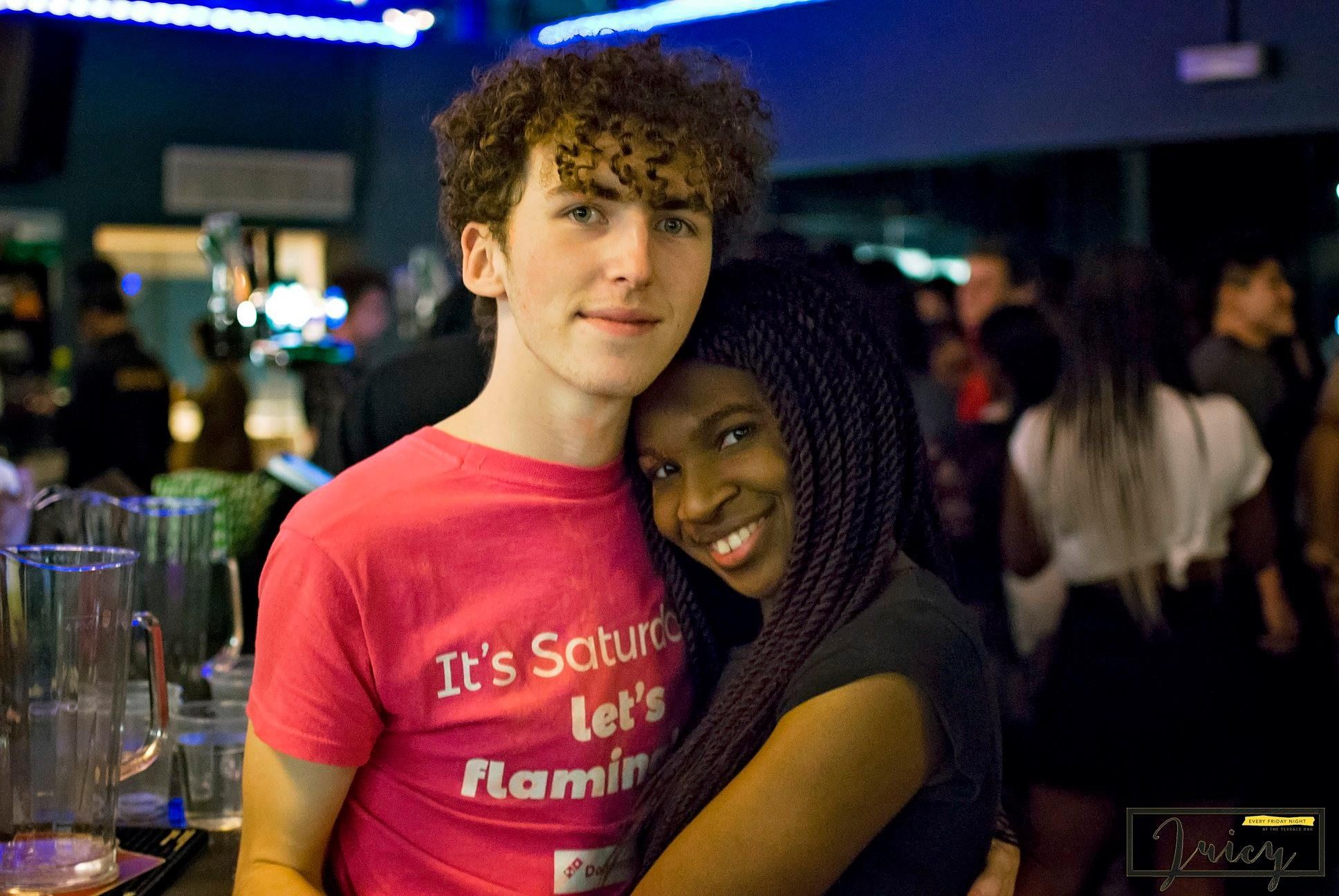 Image may contain: Bar Counter, Pub, Apparel, Clothing, Afro Hairstyle, Hair, Person, Human, Night Life