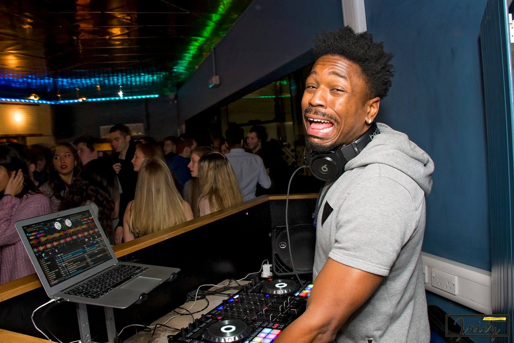 Image may contain: Club, Afro Hairstyle, Hair, Screen, Monitor, LCD Screen, Display, Computer Keyboard, Computer Hardware, Keyboard, Hardware, Dj, Laptop, Electronics, Pc, Computer, Person, Human