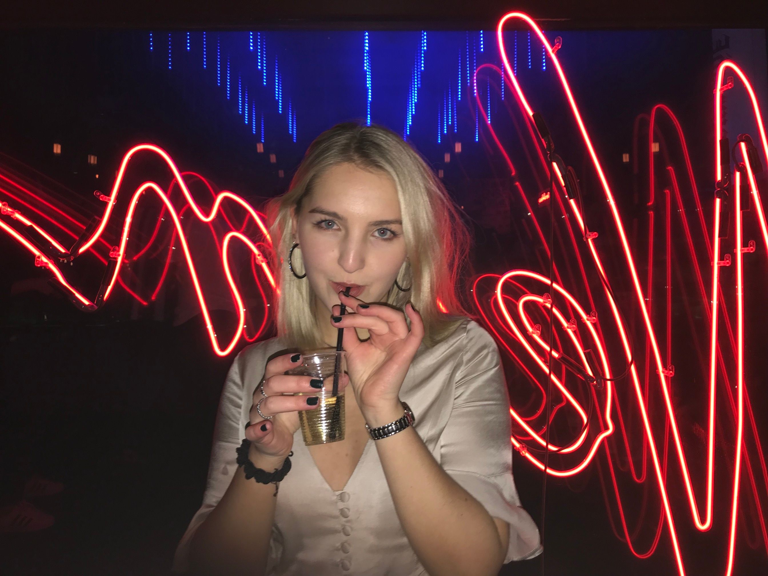 Image may contain: Finger, Lighting, Night Life, Neon, Light, Person, Human
