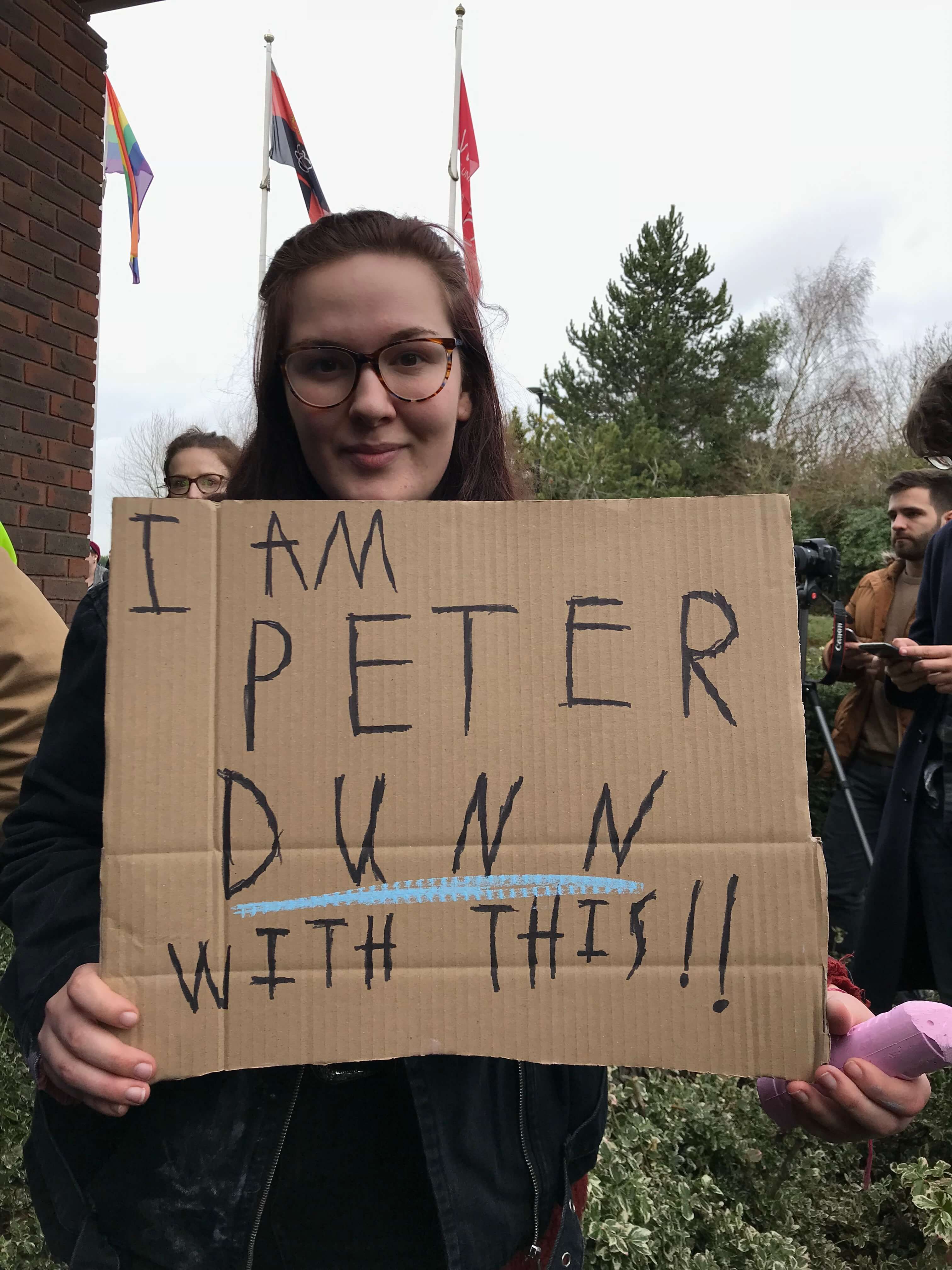 Image may contain: Crowd, Calligraphy, Banner, Handwriting, Person, Human, Text