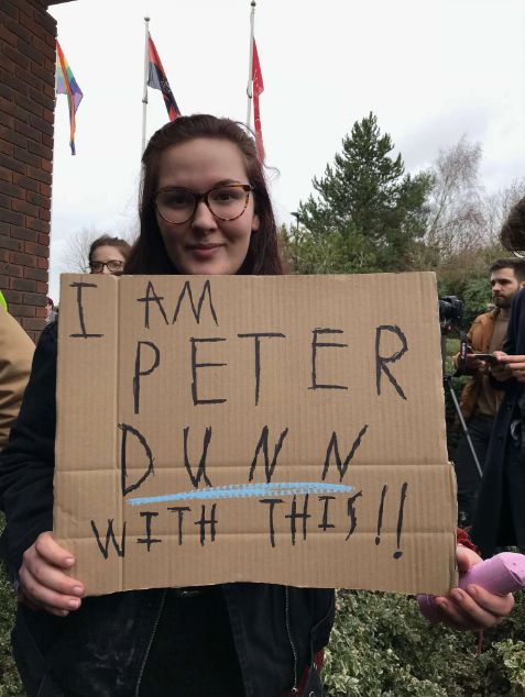 Image may contain: Parade, Crowd, Plant, Tree, Female, Photo, Photography, Portrait, Accessories, Accessory, Glasses, Handwriting, Head, Face, Person, Human, Text
