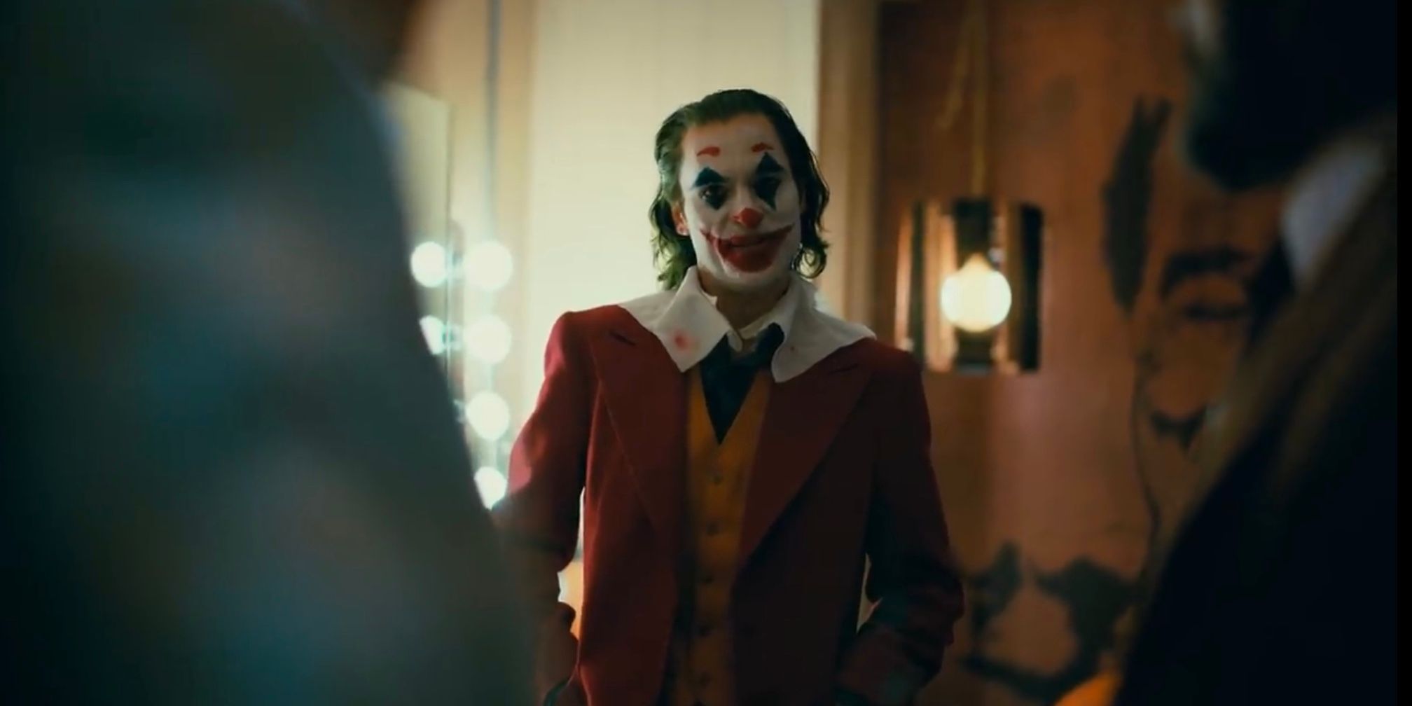 Image may contain: Suit, Overcoat, Blazer, Jacket, Coat, Clown, Clothing, Apparel, Performer, Person, Human
