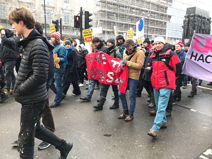 Image may contain: People, Protest, Parade, Light, Traffic Light, Crowd, Footwear, Apparel, Clothing, Shoe, Human, Person