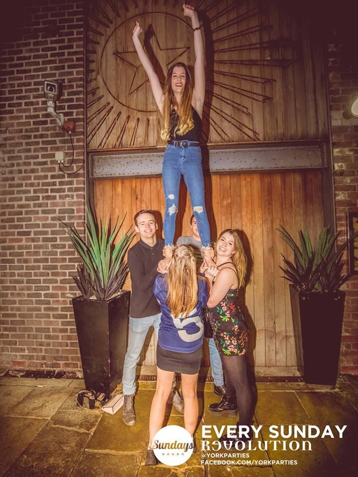 Image may contain: Poster, Pants, Jeans, Denim, Clothing, Pot, Woman, Girl, Female, Blonde, Vase, Pottery, Potted Plant, Plant, Jar, Flora, Person, People, Human
