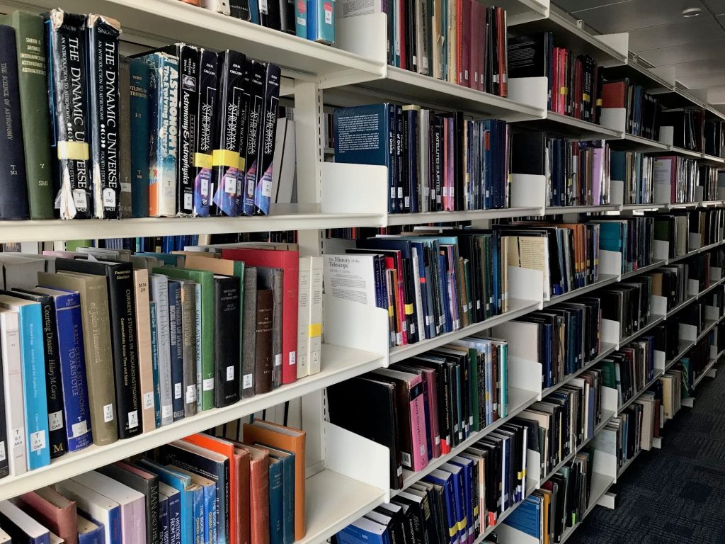 Image may contain: Book, Library, Bookcase, Indoors, Room, Shelf, Furniture