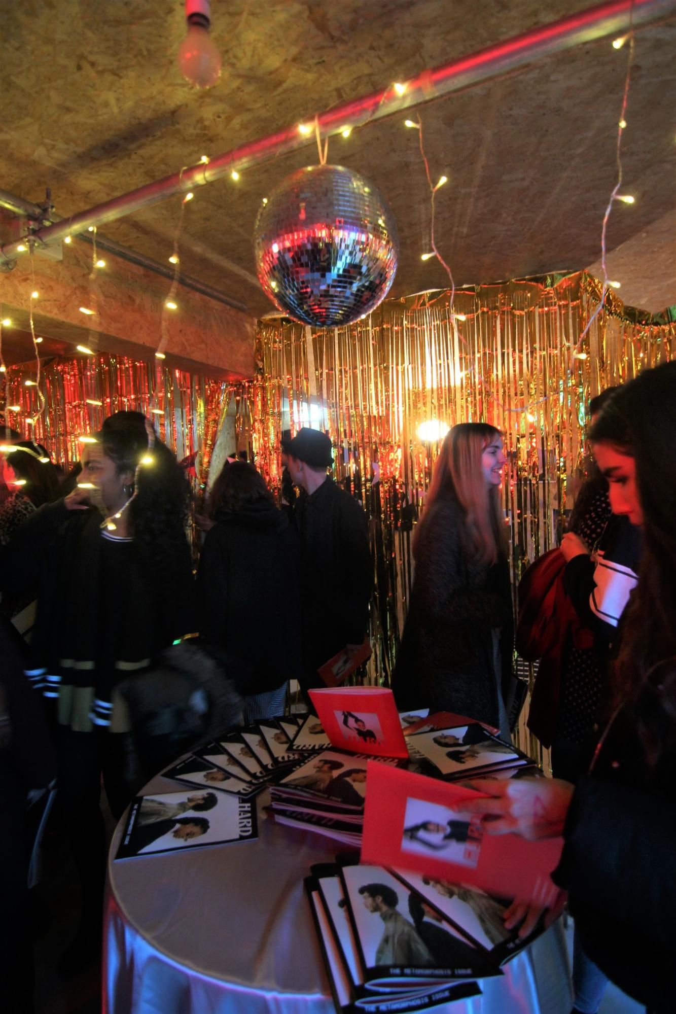 Image may contain: Bazaar, Shop, Market, Crowd, Bar Counter, Pub, Night Club, Club, Lighting, Person, Human, Night Life