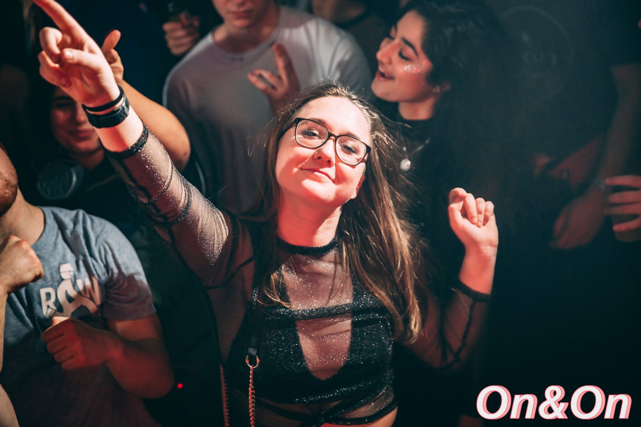 Image may contain: Leisure Activities, Finger, Party, Night Club, Club, Skin, Night Life, Accessory, Glasses, Accessories, Person, Human