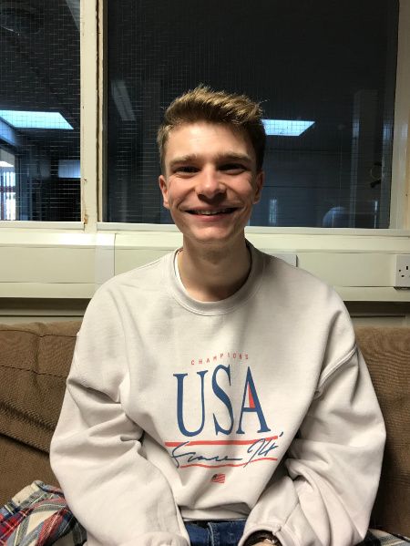 Image may contain: Sweater, Sweatshirt, Photography, Photo, Portrait, Man, Furniture, Glasses, Accessories, Accessory, Boy, Home Decor, Face, Person, Human, Apparel, Clothing