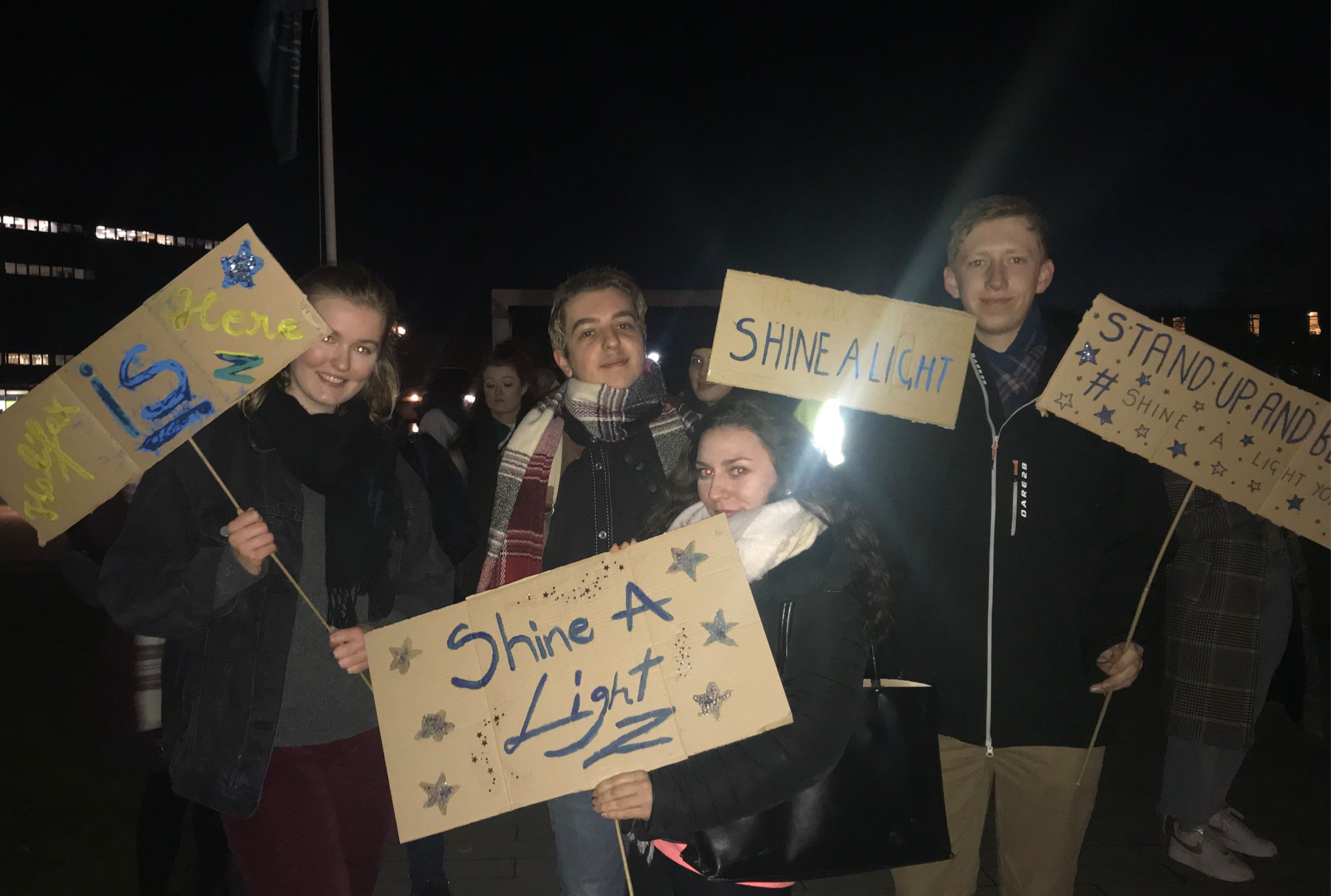 Image may contain: Apparel, Clothing, Crowd, Vigil, Text, Person, Human