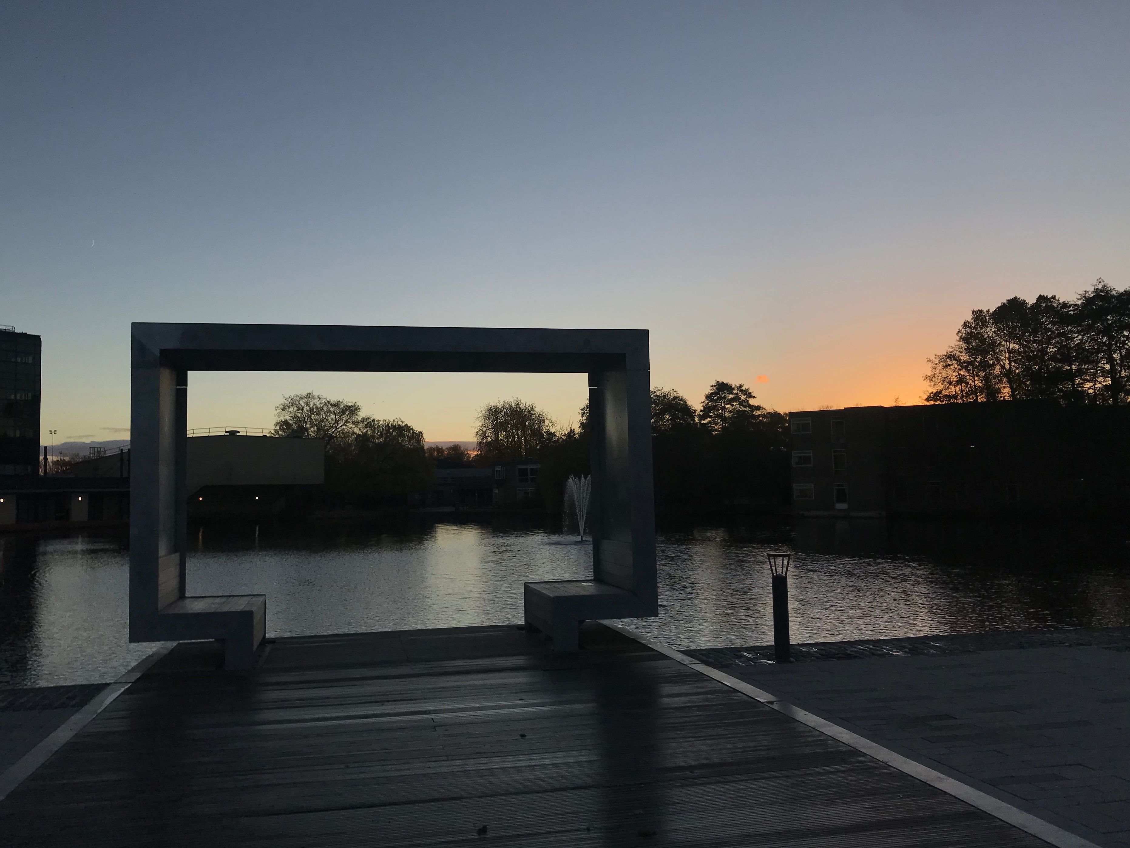 Image may contain: Porch, Silhouette, Sunlight, Bridge, Boardwalk, Building, Dock, Port, Pier, Sunset, Sky, Nature, Red Sky, Dawn, Dusk, Outdoors, Waterfront, Water
