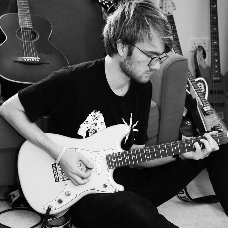 Image may contain: Electric Guitar, Musician, Performer, Guitarist, Human, Person, Bass Guitar, Guitar, Leisure Activities, Musical Instrument