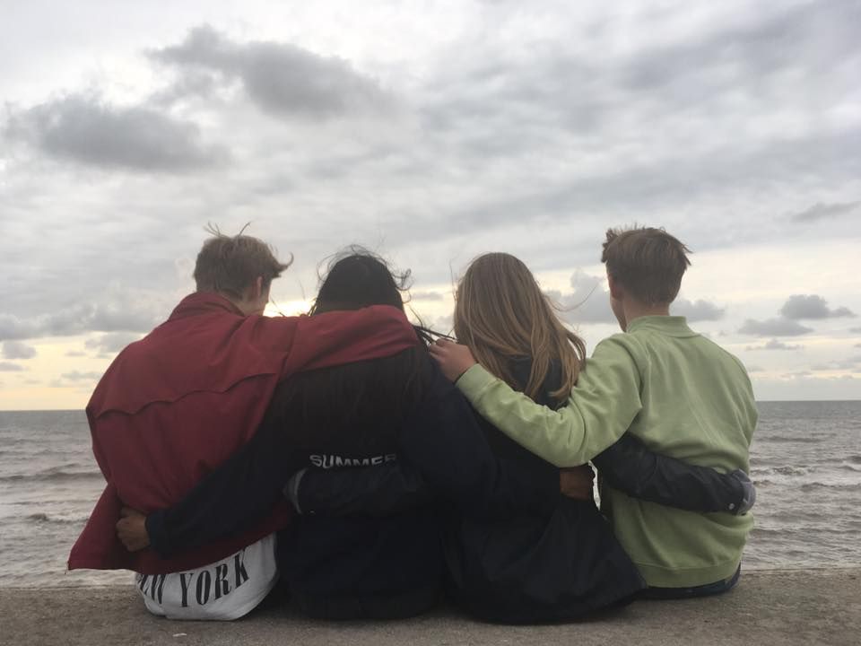 Image may contain: Pants, Jacket, Water, Coat, People, Hug, Sitting, Shoe, Footwear, Nature, Landscape, Outdoors, Panoramic, Scenery, Human, Person, Clothing, Apparel